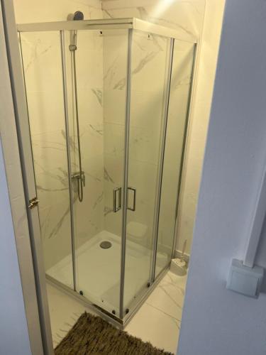 a glass shower stall in a room at Casa da alegria in Vieira de Leiria