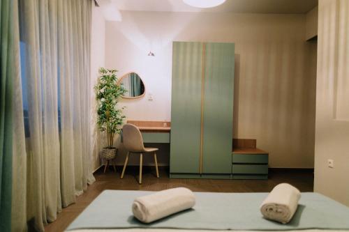 a dressing room with a bed and a mirror at Anassa House in Alexandroupoli