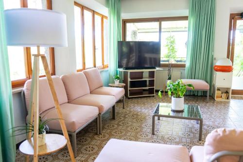 a living room with a couch and a tv at Eden Park Hotel in Marina di Campo