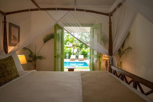 a bedroom with a large bed in a room at Zen Villa in Ahangama