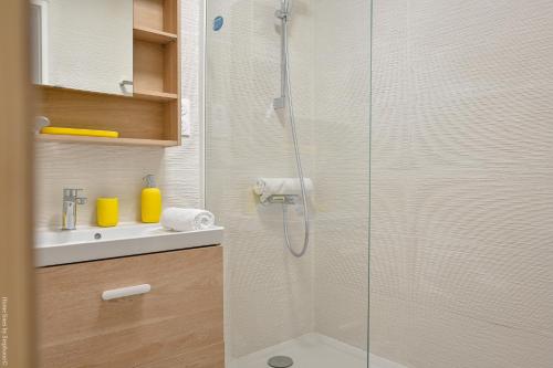 une douche avec une porte vitrée à côté d'un lavabo dans l'établissement Marseille Centre - Appartement 3 Chambres avec Balcon, à Marseille
