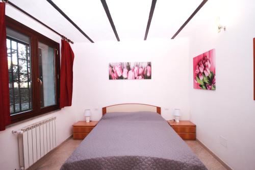 a bedroom with a bed and two pictures on the wall at Capalbio - Retreat in Capalbio