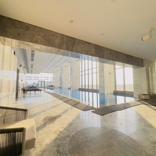 a large lobby with a swimming pool in a building at Marakez Aeon Towers in 6th Of October