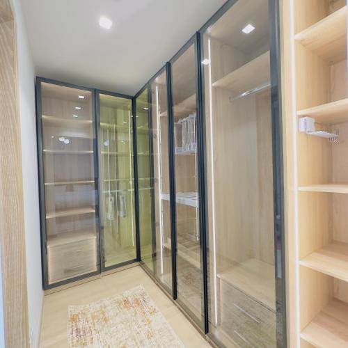 a walk in closet with glass doors and a rug at Marakez Aeon Towers in 6th Of October