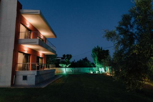 a night view of a house with lights on at Anassa House in Alexandroupoli