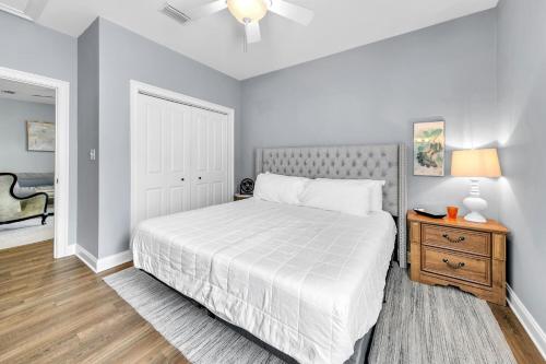 a bedroom with a white bed and a wooden table at Topsail Village 322 in Grosh