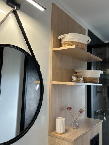 a black mirror sitting on a shelf in a room at Leśny Park Polanica in Szczytna
