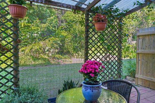 a table with a vase of flowers on a patio at Botanical Bliss in Edge Hill