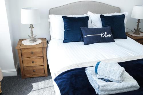 a bedroom with a bed with blue and white pillows at Portsmouth Apartment *Newly refurbished *Central in Portsmouth