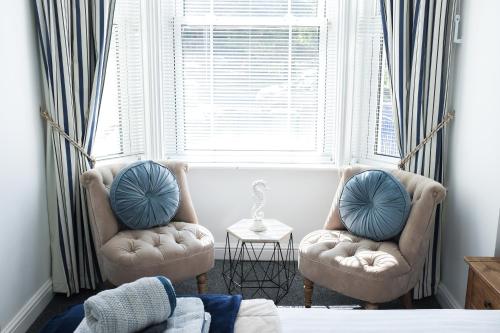 two chairs sitting in a room with a window at Portsmouth Apartment *Newly refurbished *Central in Portsmouth
