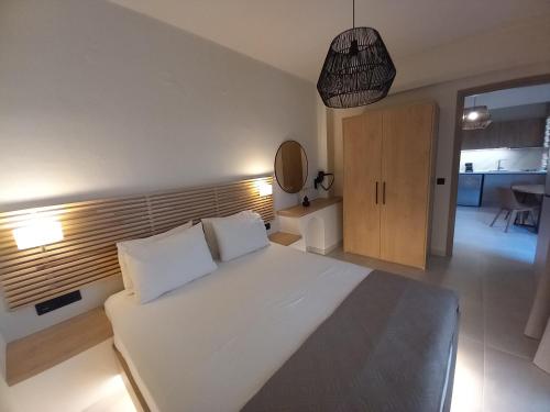 a bedroom with a large white bed in a room at Nancy - Chara Apartments in Karteros