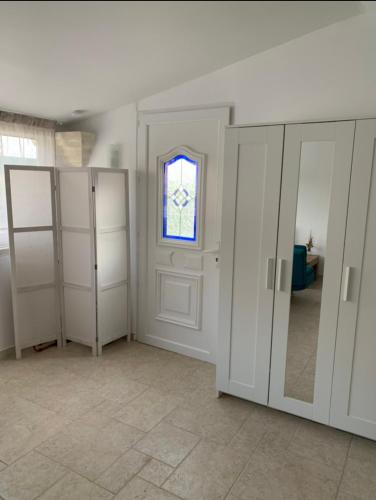 a room with white closets and a window at Studio le soleil couchant in Saint-Saturnin-lès-Avignon