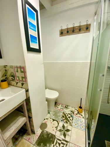 a bathroom with a toilet and a sink at The Summer Treat Shared Apartment Compartido in Corralejo