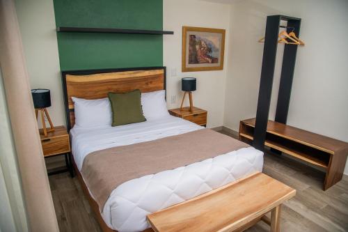 a bedroom with a large bed and a desk at Quinta Mercedes in Guanajuato