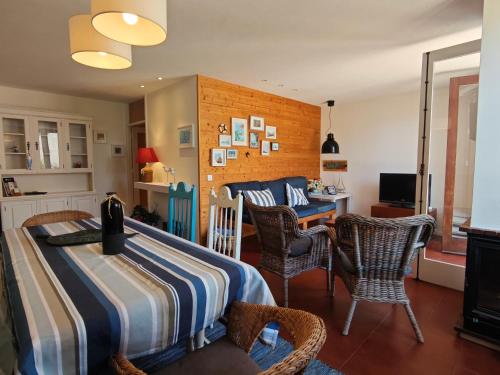 a bedroom with a bed and a table and chairs at Casa na praia - com piscina in Esmoriz