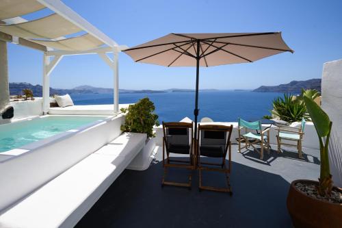 a house with a swimming pool and an umbrella at Sophia Oia View in Oia