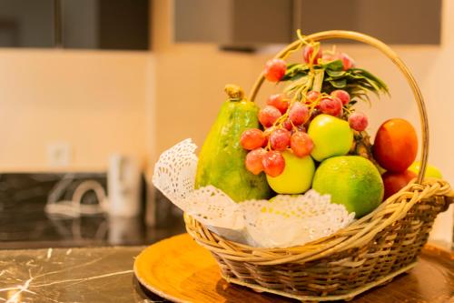 a basket of fruit sitting on a table at Bano Palace Hotel in Douala
