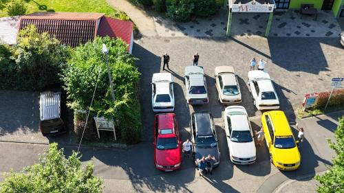a group of cars parked in a parking lot at Hotel Strand-Café in Roßbach