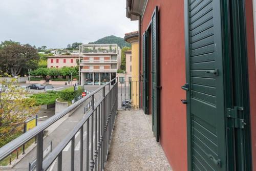 a balcony with a green door and a building at Loft Gelsomino, by R Collection apartment in Cernobbio