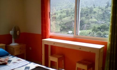a room with a window and a bed and a table at SANDRO Paul Residenciel in Paul