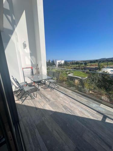 a patio with a table and chairs on a balcony at Retreat B1-9 in Akanthou
