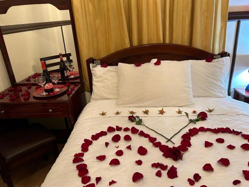 a bed with a heart made out of roses at Hostal CASA FRANCISCANA in Quito