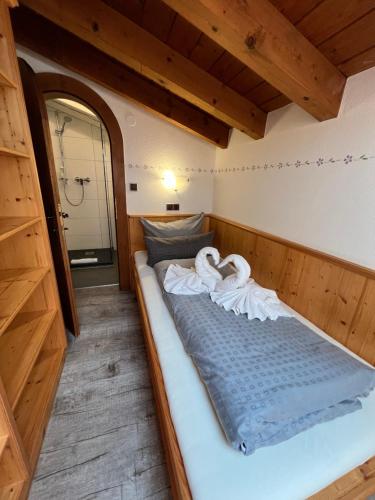a bed in the middle of a room at ALPENHOTEL TYROL - B&B - ADULTS ONLY - Alpines Lifestyle-Konzepthotel - dog friendly in Pertisau