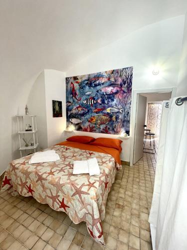 a bedroom with a bed and a painting on the wall at Casa Vacanze Perla Marina in Marsala