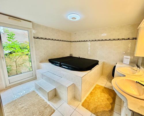 a bathroom with a tub in the corner of the room at Beausoleil SPA Villa XL-Geneva & Lake & Mountains-Wilena Home, Full Love in Chens-sur-Léman