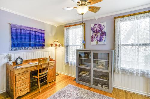 a home office with a desk and a ceiling fan at Granbury Home with Fire Pit, Walk to The Square! in Granbury