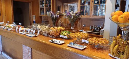 a buffet line with many different types of food at Turim Club Azeitao Hotel in Setúbal