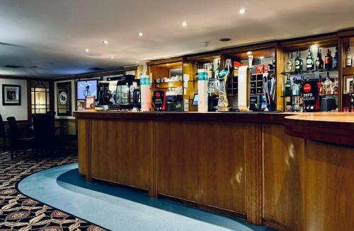 a bar in a pub with a lot of alcohol at Carrington House Hotel in Bournemouth