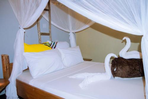 a bedroom with two swans on a bed at Kilimanjaro Scenic Homestay in Moshi