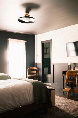 a bedroom with a bed and a table and chairs at The Madison Hotel in Dallas