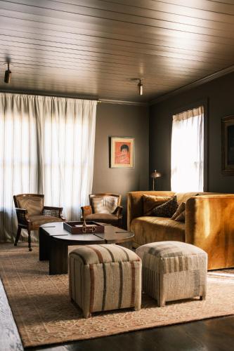 a living room with a couch and a table at The Madison Hotel in Dallas