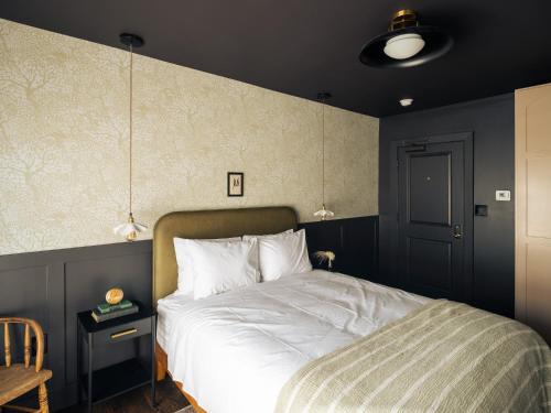 a bedroom with a bed and a blue wall at The Madison Hotel in Dallas