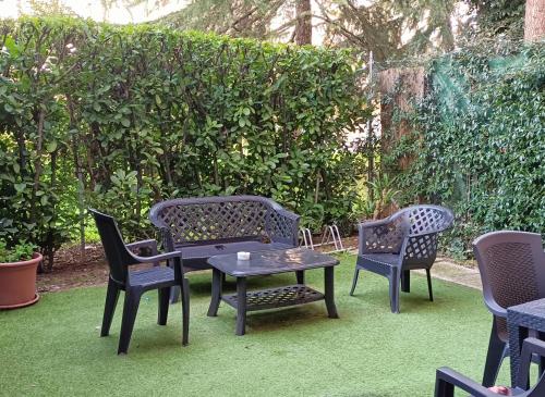 a group of chairs and a table and chairs on a lawn at Residence Venice in Quarto dʼAltino