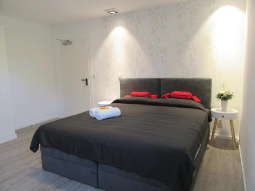 a bedroom with a bed with red pillows on it at Minsu Hotel in Mülheim an der Ruhr