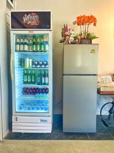 a refrigerator filled with lots of bottles of soda at Van Vliet Hostel in Phra Nakhon Si Ayutthaya