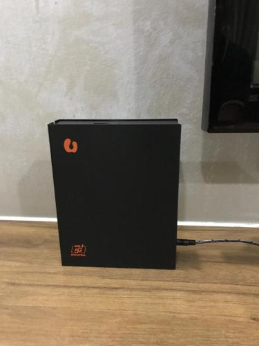 a black box sitting on top of a wooden floor at Fidaiy Homestay in Teronoh