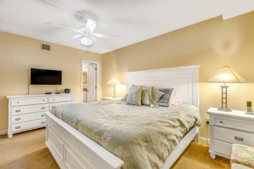 a bedroom with a white bed and a tv at Sea Colony - 509 Dover House Rd. in Bethany Beach