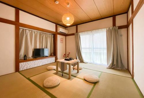 a living room with a table and a tv at New Super Deals Now Available Direct Access to Akihabara Shinjuku and Disneyland in Tokyo
