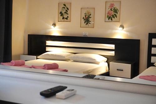 a reflection of a bedroom with a bed in a mirror at Marku Palace in Ksamil