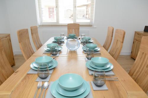 a wooden table with blue bowls and plates on it at The Orchard in Telford