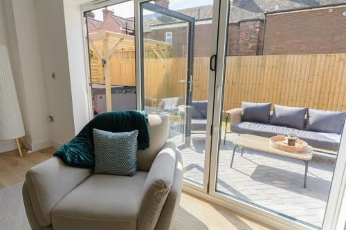a living room with a couch and a sliding glass door at The Orchard in Telford