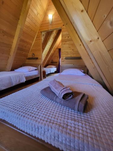 a bedroom with two beds in a attic at Monte Diva Zabljak in Žabljak