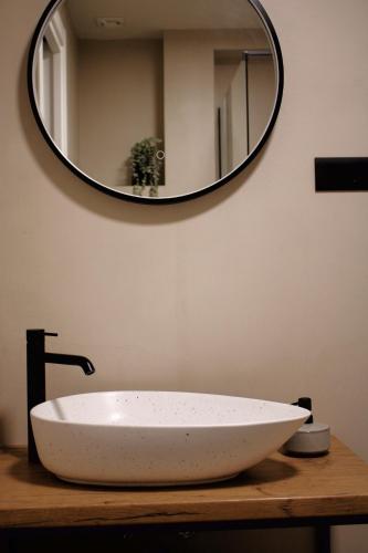 a bathroom sink with a large mirror on the wall at PaMar Downtown Apartments in Split