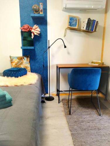 a bedroom with a bed and a desk and a chair at Delightful tiny river-view home in Šamorín