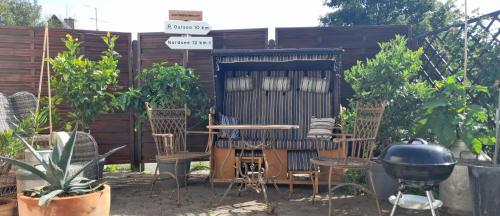 a patio with chairs and a table and a grill at Holiday apartment & boat rental in Sindal