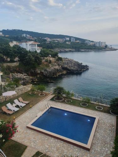 a swimming pool with a view of the ocean at Aurora Spa in Kunje